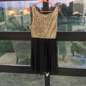 Black with gold sequins. Size large. Zipper back.